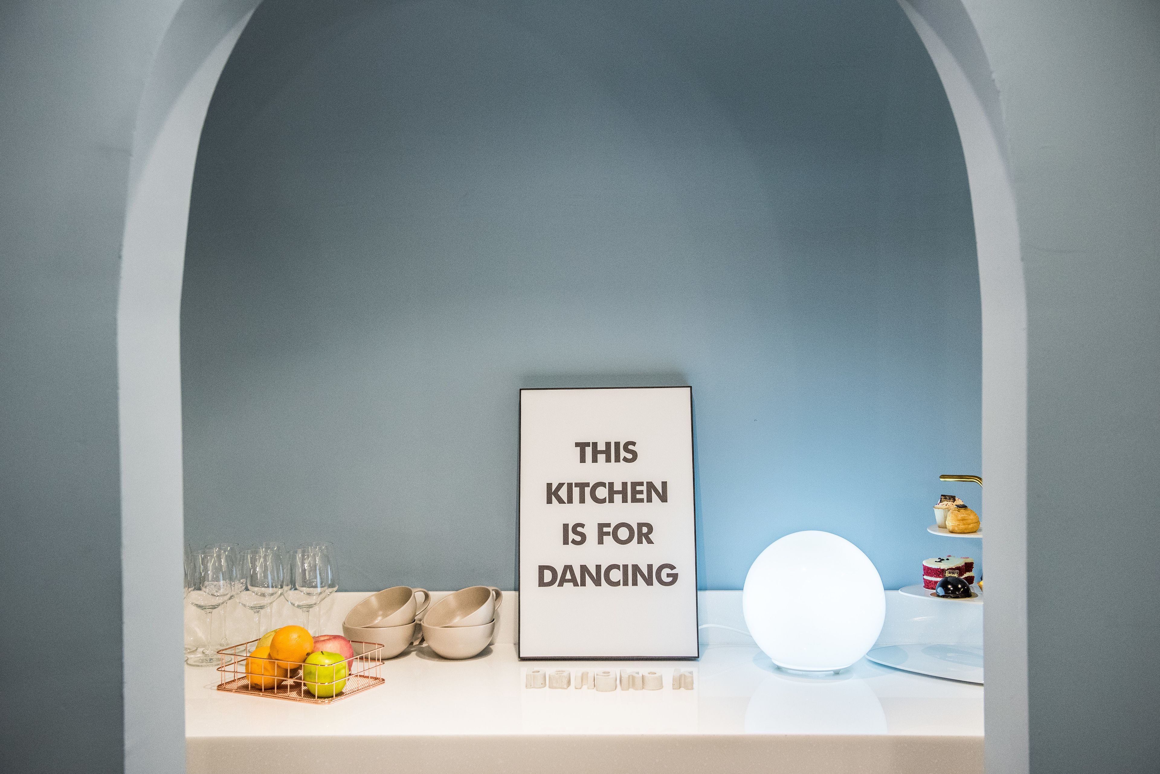 A kitchen with a sign stating "THIS KITCHEN IS FOR DANCING."