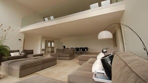 A spacious living area with a high ceiling, a mezzanine level, and a modern design. - Directly at the Wadden Sea, part of UNESCO World Heritage. Calm/Fun at beach (Wierum)