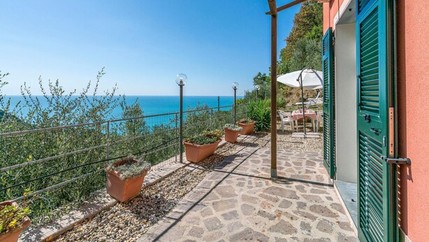 A terrace with a view of the sea, potted plants, and outdoor furniture. - 2 bedroom awesome home in Framura (SP) (Framura (SP))
