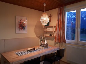 Enjoy meals in this cozy dining area with a view of the surrounding mountains.