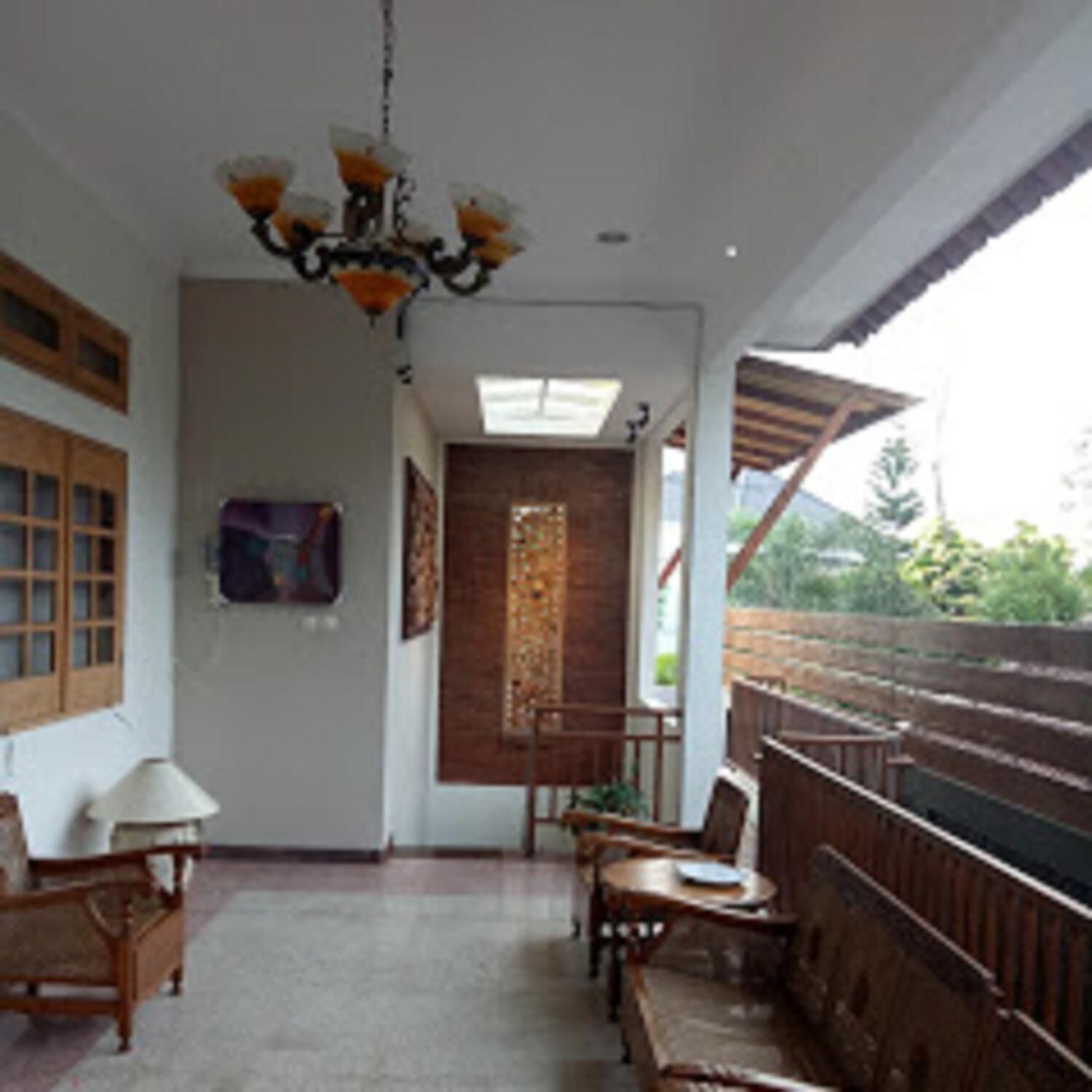 A room with a wooden bench, a table, and a hanging light fixture.