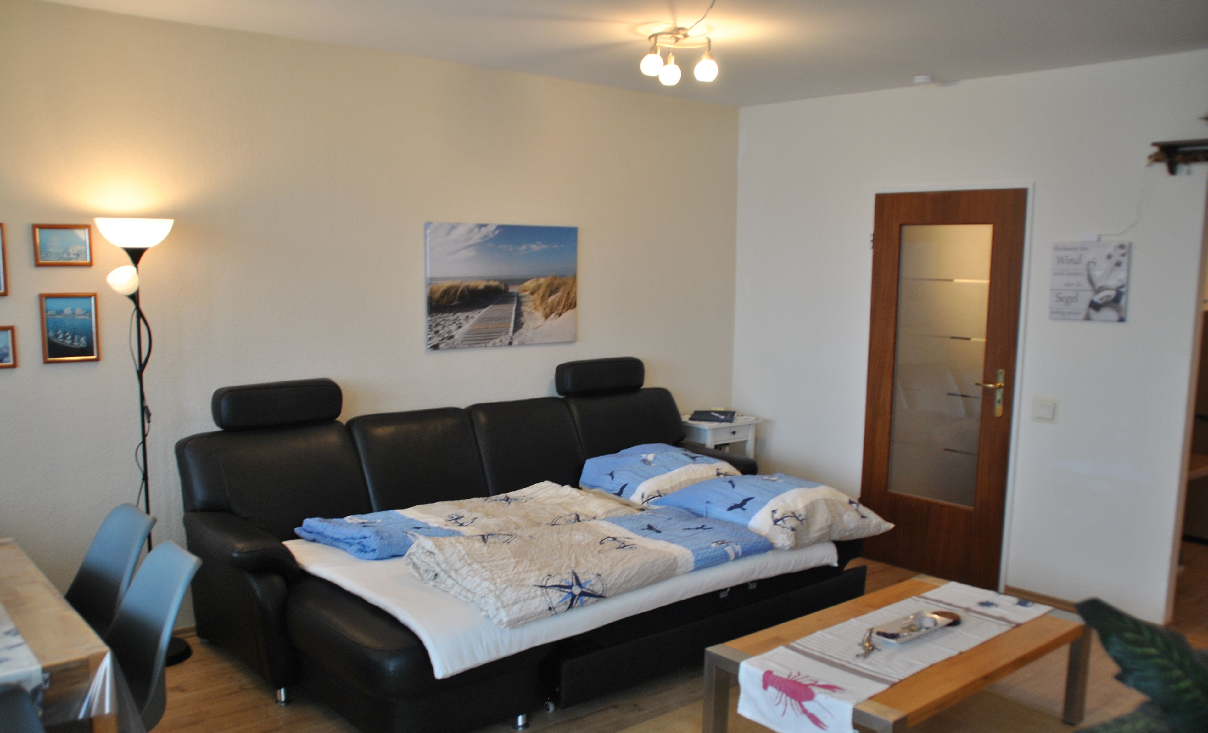 A modern bedroom with a bed, a desk, and a chair.