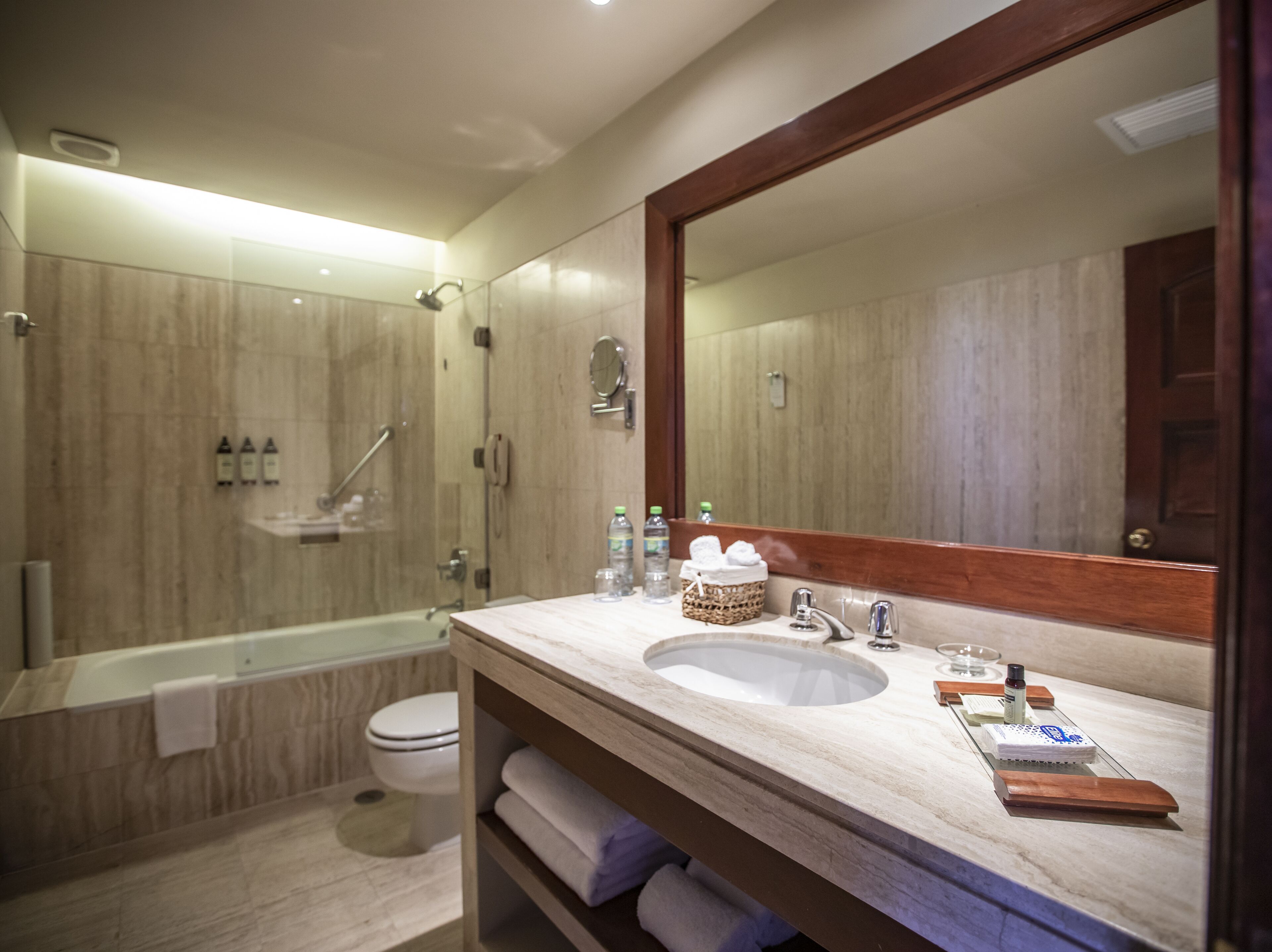 A modern bathroom with a bathtub, toilet, and sink.