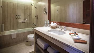 A modern bathroom with a bathtub, toilet, and sink.
