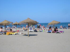 On the beach, sun-loungers, beach towels