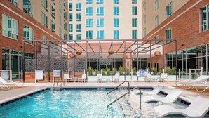 An indoor swimming pool with lounge chairs and a covered seating area. - Residence Inn by Marriott Greenville Downtown (Greenville)
