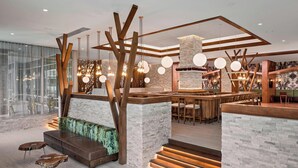 A modern interior with a bar area, seating, and a staircase. - Residence Inn by Marriott Greenville Downtown (Greenville)
