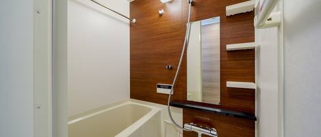A modern bathroom with a wooden vanity, a bathtub, and a shower.