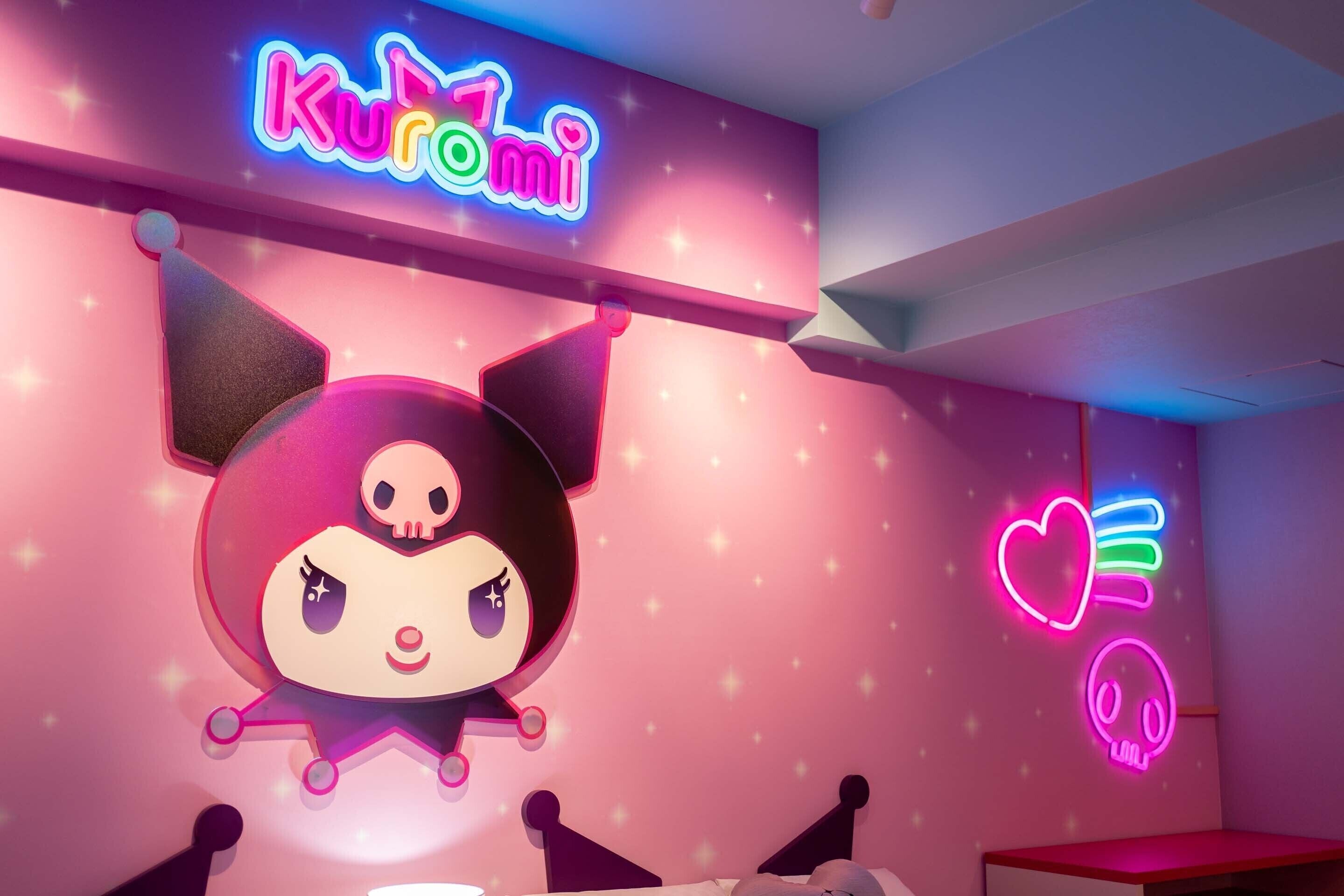 A room with a neon sign reading "Kuromi" and a cartoon character decoration.