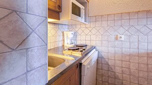 A compact kitchen with a built-in microwave, a coffee maker, and a dishwasher. - Divisible studio 4ppl, ski-in/ski-out, pets allowed - Valmorel (Valmorel)