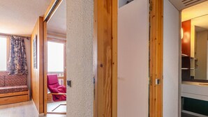 A modern interior with a wooden bench, a red chair, and a white cabinet. - Divisible studio 4ppl, ski-in/ski-out, pets allowed - Valmorel (Valmorel)