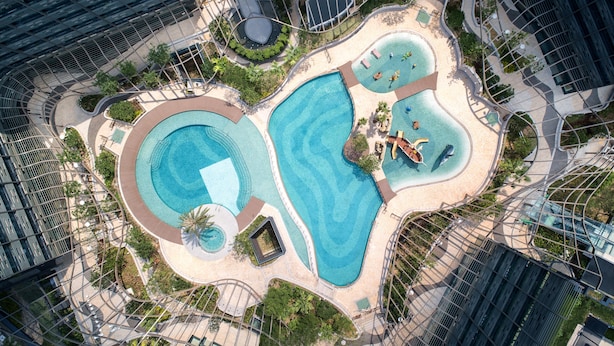 An aerial view of a resort with multiple swimming pools, landscaped areas, and modern architecture. - Hong Kong Ocean Park Marriott Hotel (Hong Kong)