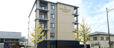 A multi-story building with a sign reading "RESI STAY Gojozaka".