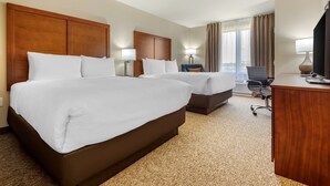 A hotel room with two beds, a desk, a chair, and a TV. - Comfort Inn & Suites (Greater Napanee)