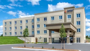 A hotel with a flat facade, multiple windows, and a sign for Comfort Inn Suites. - Comfort Inn & Suites (Greater Napanee)