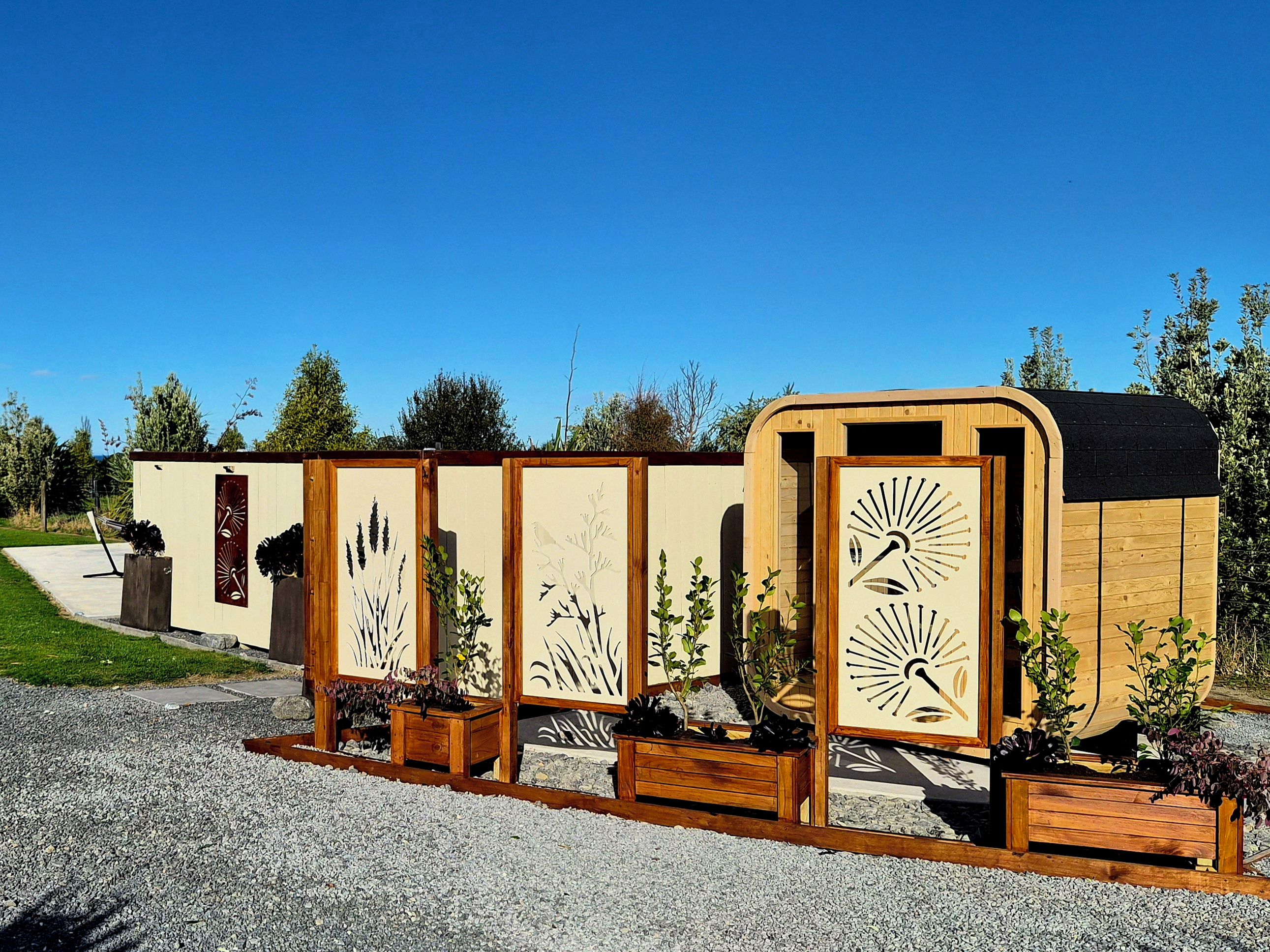 A row of wooden structures with artistic cut-out designs, possibly a themed attraction or art installation.