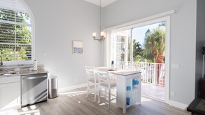 A modern kitchen with a dining area, large windows, and a view of the outdoors. - Amazing Pet Friendly Condo w/ Pool a Block to Siesta Key Village, Newly Updated (Sarasota)