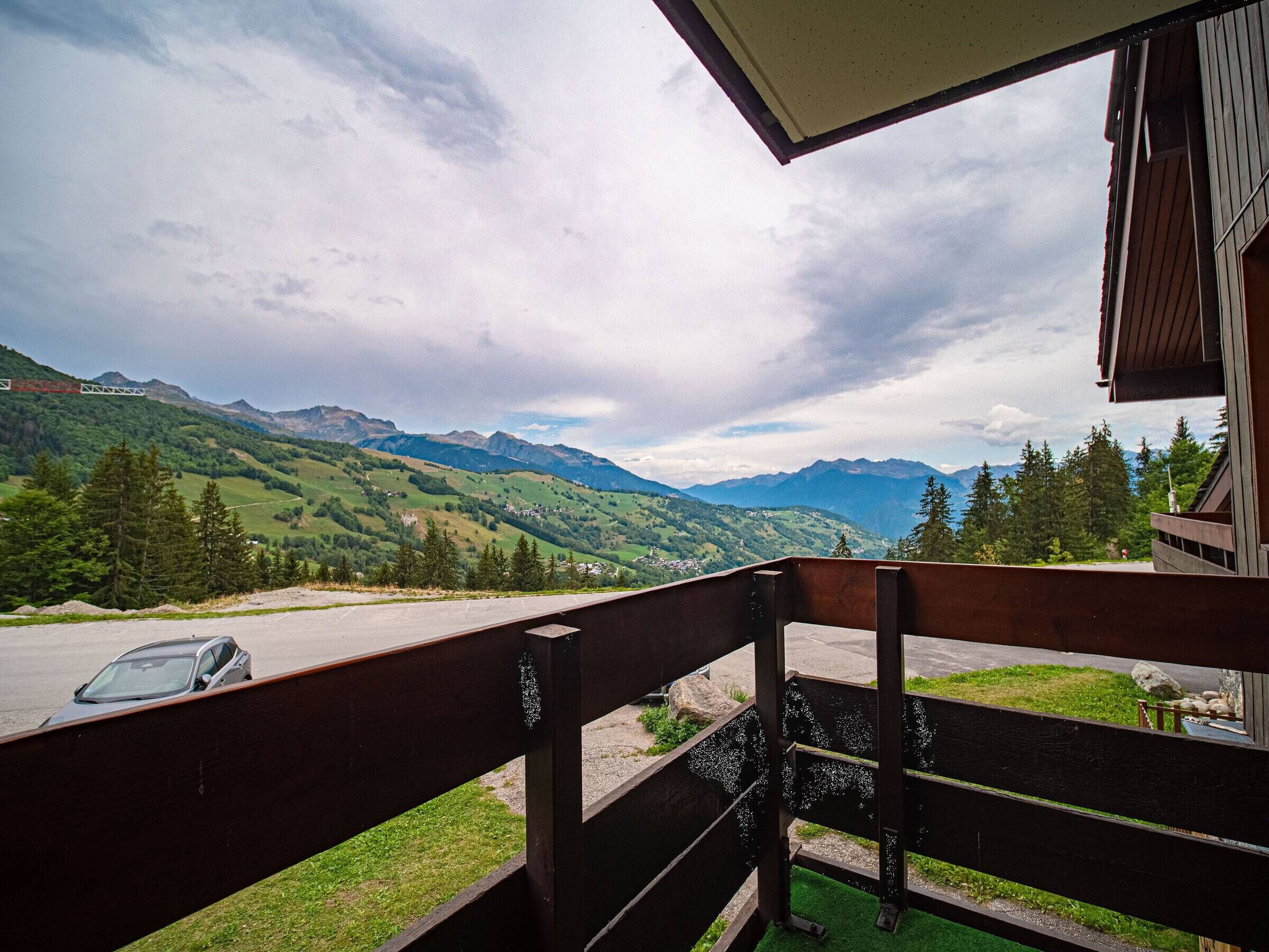 A balcony with a view of a mountainous landscape.