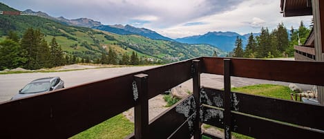 A balcony with a view of a mountainous landscape.