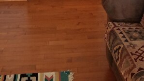 A wooden staircase in a room with a patterned rug and a couch. - WIFI!! Big Oak Cabin, ozarks, hot tub, rivers! (Tecumseh)