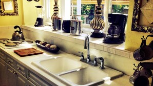A kitchen with two sinks, a kettle, and various appliances. - VOTED BEST FORT LAUDERDALE LOCATION! WALK TO SHOPS, RESTURAUNTS, & BEACH. (Ft Lauderdale)