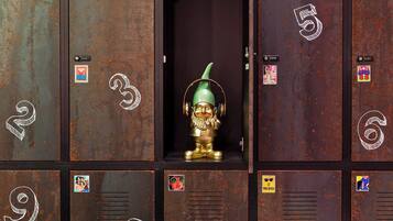 A row of numbered lockers with a golden statue in the center.