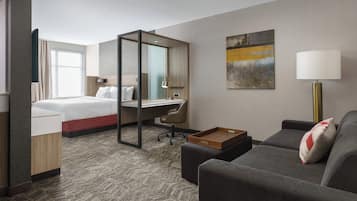 Hypo-allergenic bedding, desk, laptop workspace, blackout drapes
