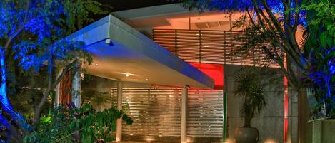 A modern building with a sloped roof and a covered entrance area.