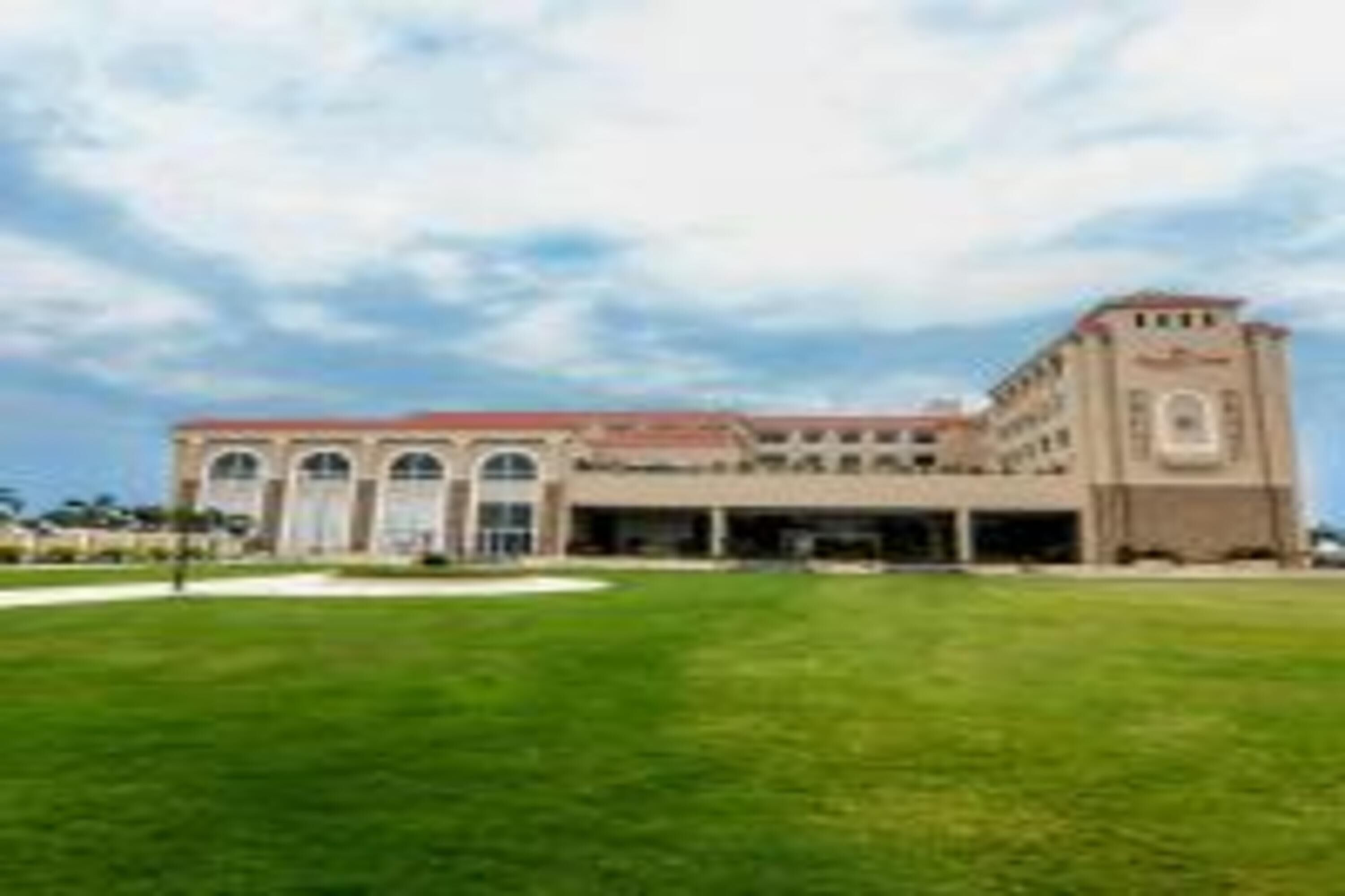 A large building with a central courtyard and arched windows.