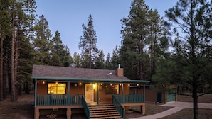 A lodge with a porch, a staircase, and a chimney. - Fireplace nights, starry skies, wildlife mornings! (Parks)