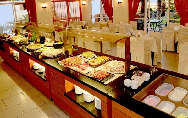 A buffet setup with various food items and a buffet counter.