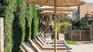Seasonal outdoor pool, open 9:00 AM to 8:00 PM, pool umbrellas