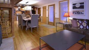 A spacious living area with a dining table, chairs, a sofa, and a lamp. - Maroon Bells (Crested Butte)