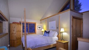A bedroom with a four-poster bed, a wooden wardrobe, a desk, and a chair. - Maroon Bells (Crested Butte)