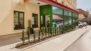 A hotel with a green awning, a sign reading "Hotel Park 45", and a row of small trees along the sidewalk. - Hotel Park 45 (Zagreb)