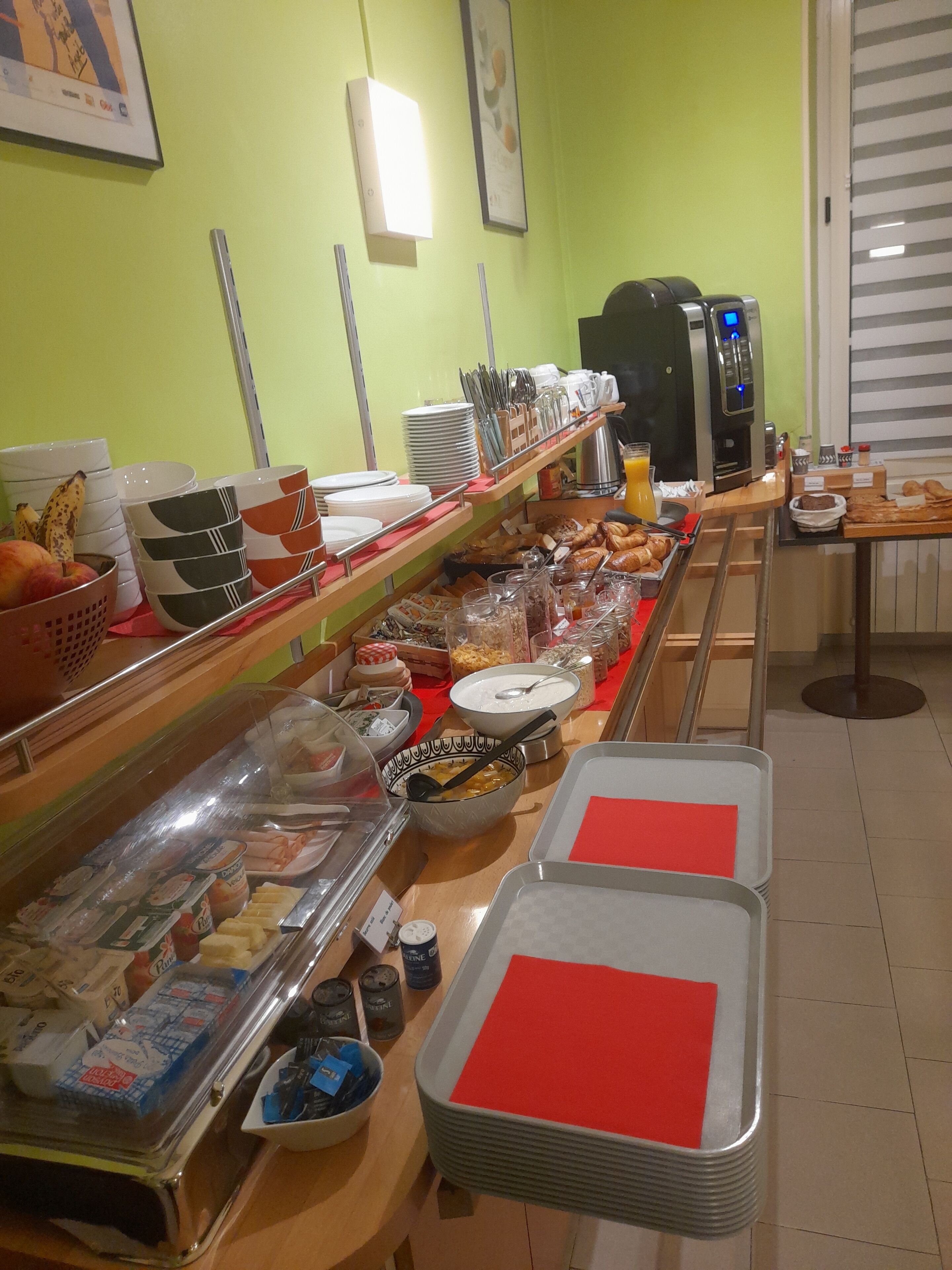 A buffet setup with various food items and utensils.