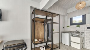 Een compacte keuken met een inbouwkast, een kleine koelkast en een raam met uitzicht.