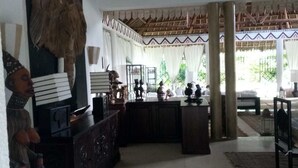 A room with a thatched roof, a wooden cabinet, and a view of greenery outside. - Diamond home 001 (Malindi)