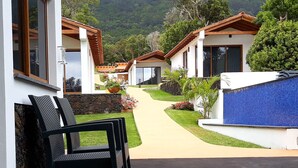 A pathway leading to a row of modern houses with a pool on the right. - Villas Casteletes-bangalow Sea View (Velas)