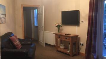 Family Apartment, Multiple Beds, Non Smoking | Living room | Flat-screen TV, video-game console