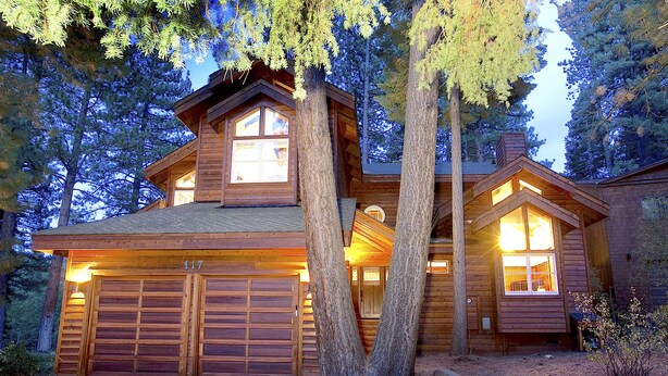 A log cabin with a garage, large windows, and a chimney. - Northstar Luxury Lodgepole 4 Bedroom Home by RedAwning (Truckee)