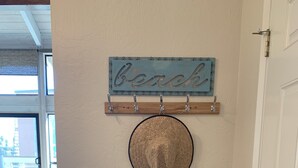 A wooden console table with a woven basket, a decorative plate, and a Santa Cruz book.