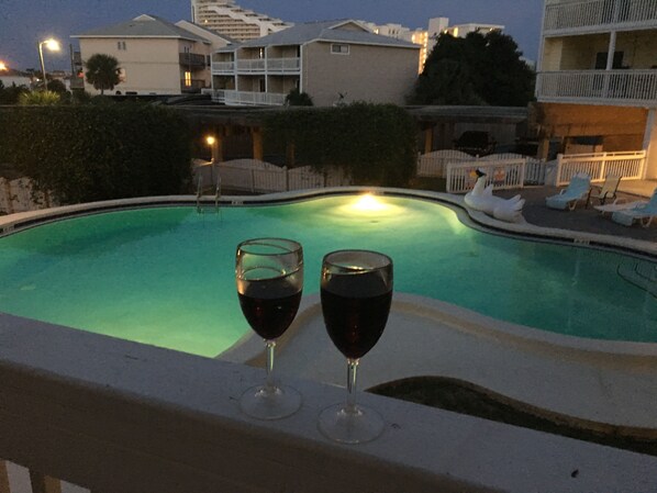 A swimming pool with two glasses of red wine on the edge. - Family Friendly & Quiet Riverside Condo with Pool & Fishing Piers (Pensacola)