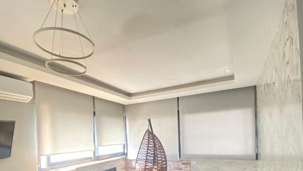A modern bathroom with a bathtub, a hanging chair, and a ceiling light fixture. - Samsun Osmanli Otel (Samsun)