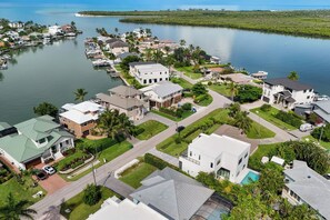 A residential area with houses, a marina, and a body of water.