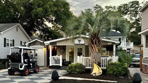 A coastal cottage with a checkered driveway, a golf cart, and a palm tree. - site Y05, Best 2 bedroom in Ocean Lakes! Golf cart included 
pet friendly (Myrtle Beach)