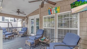 A covered porch with wicker furniture, a ceiling fan, and a 'Beach' sign. - site Y05, Best 2 bedroom in Ocean Lakes! Golf cart included 
pet friendly (Myrtle Beach)