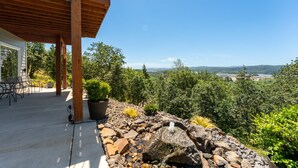 A covered patio with a view of a mountainous landscape.