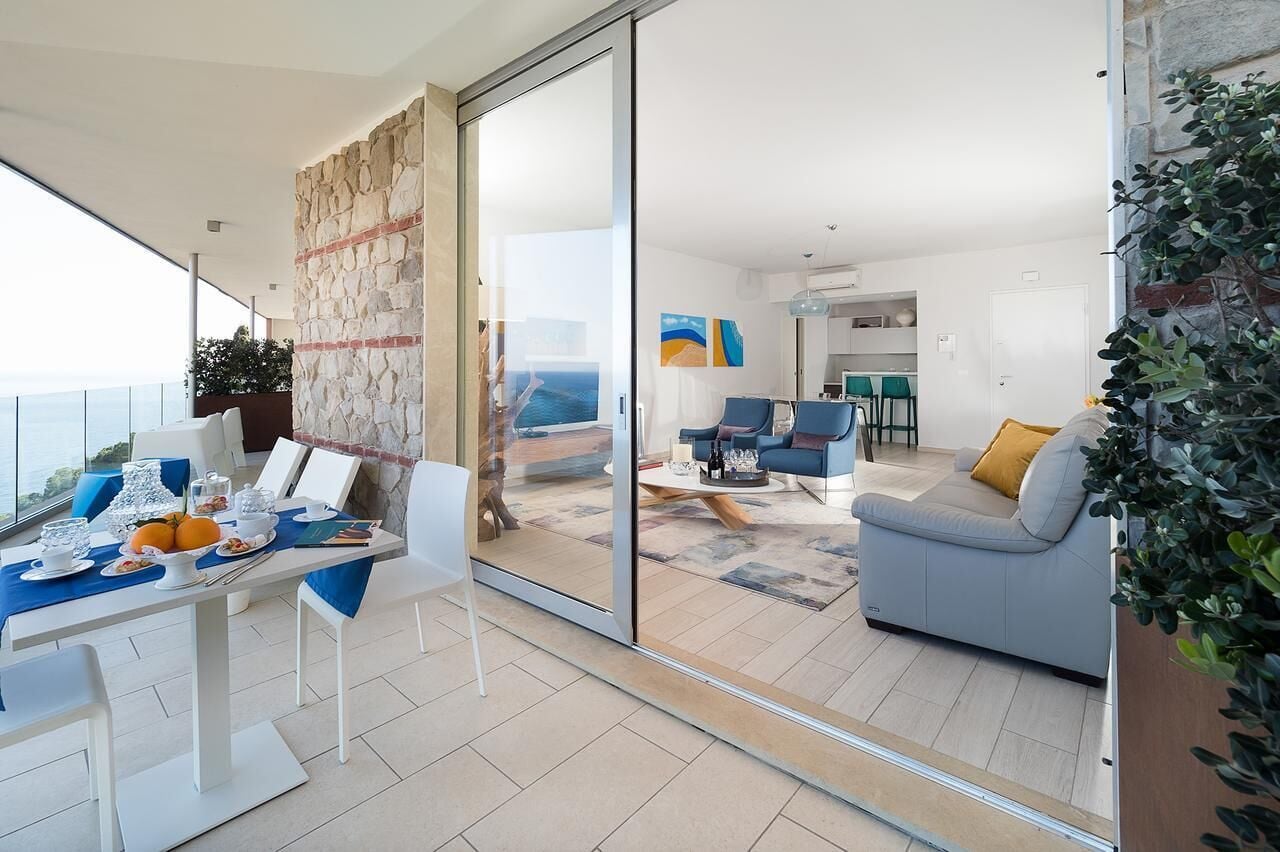 A modern living area with a dining table set, a sofa, and a coffee table.