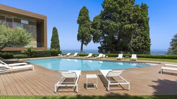 Una piscina al aire libre, tumbonas